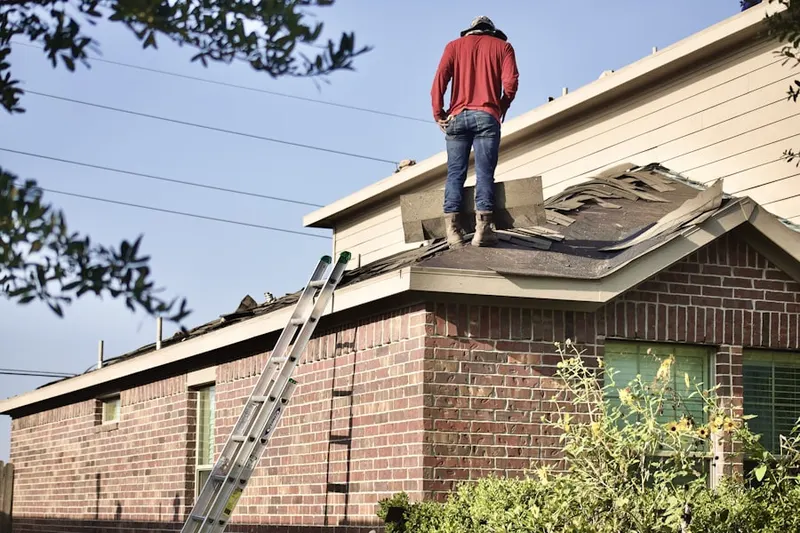 Professional roofer working on a residential roof in Wooded Acres